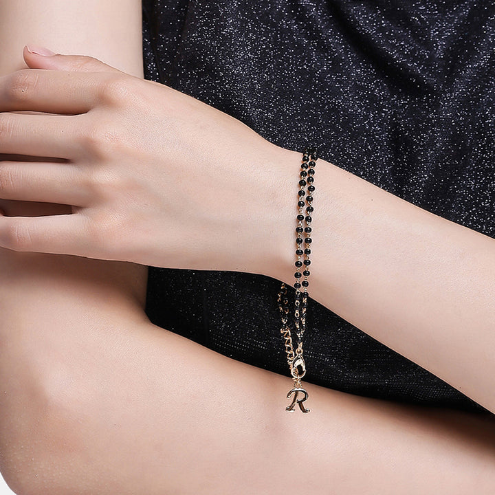 Estele Gold Plated Fascinating "R" Alphabet with Black Beads Bracelet for Women