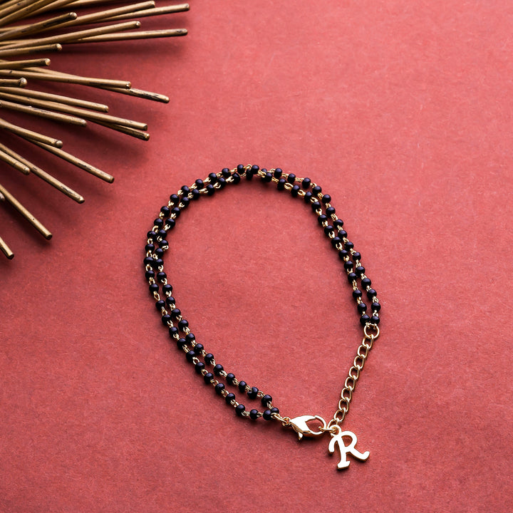 Estele Gold Plated Fascinating "R" Alphabet with Black Beads Bracelet for Women