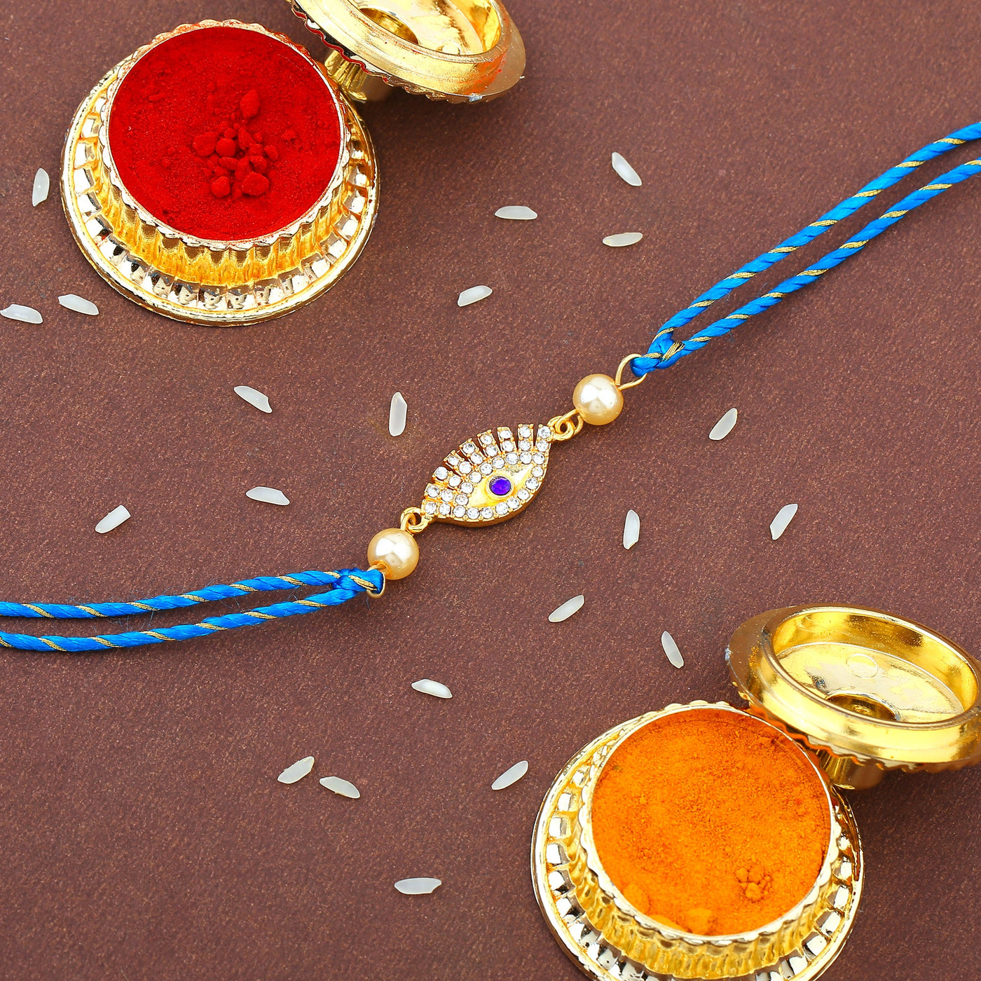 Estele Gold Plated Sacred Evil Eye Rakhi Set for Bhaiya Bhabhi with White & Blue Austrian Crystals and Fancy Silk Thread
