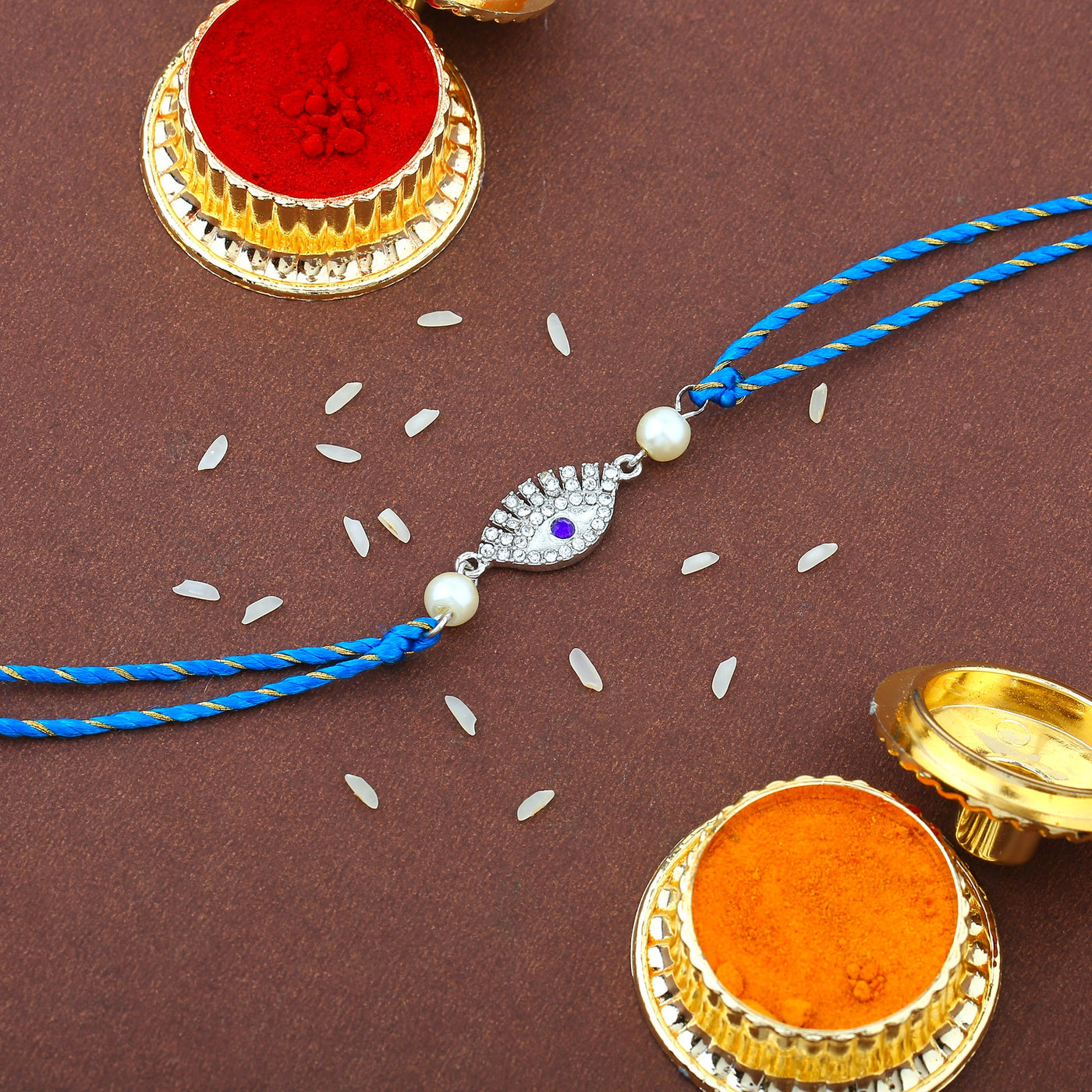 Estele Gold Plated Sacred Evil Eye Rakhi Set for Bhaiya Bhabhi with Austrian Crystals and White Pearls with Fancy Silk Thread