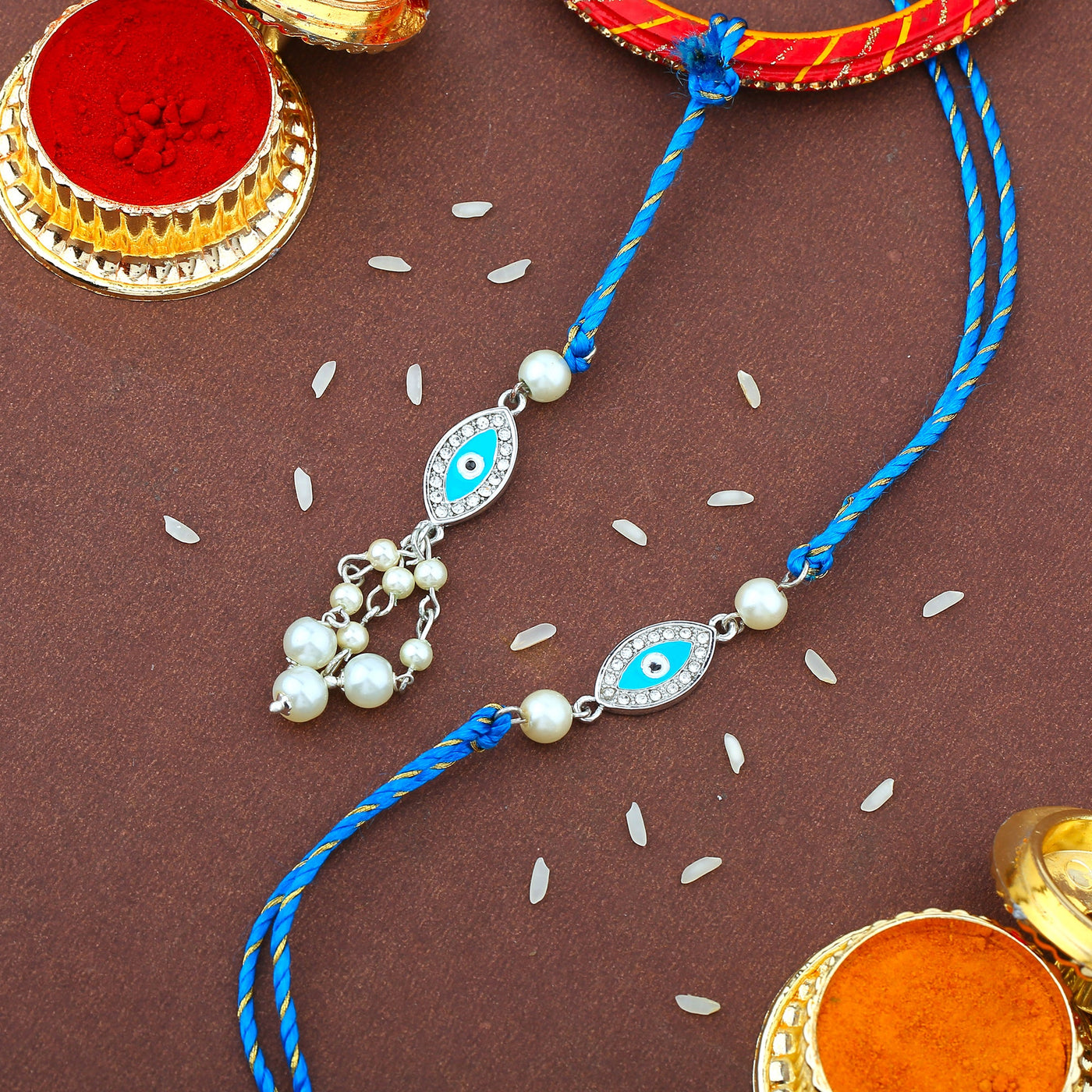 Estele Rhodium Plated Evil Eye Rakhi Set for Bhaiya Bhabhi with Blue Enamel and WhiteAustrian Crystals & Pearls with Fancy Silk Thread
