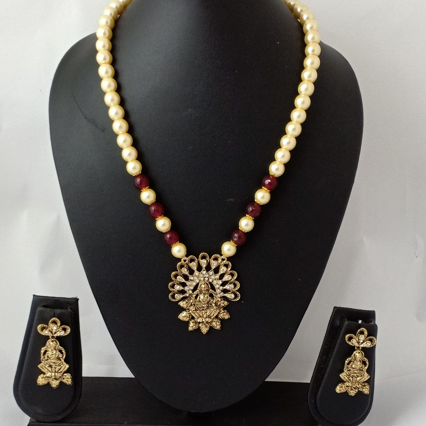Estele Gold Plated Exquisite Laxmi Devi Pearl Necklace Set with Austrian Crystals & Red Beads for Women