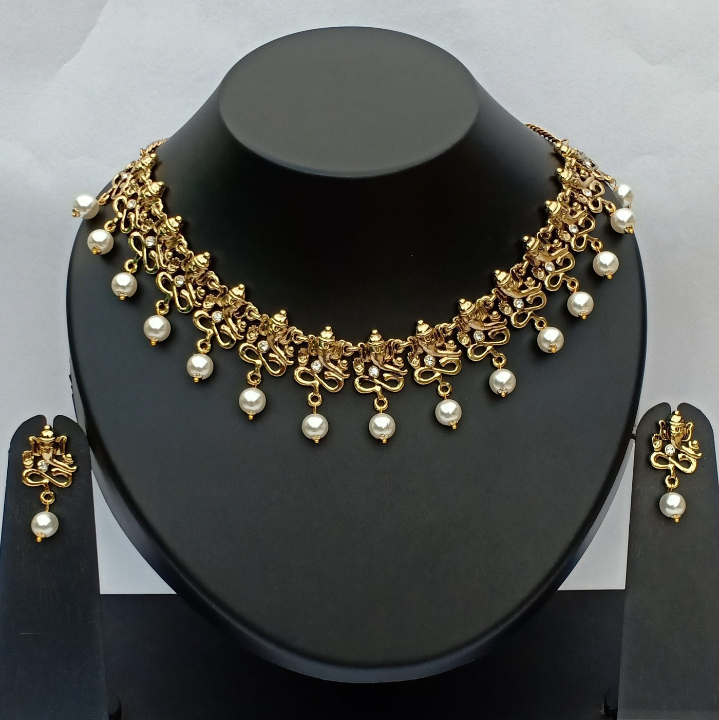 Estele Gold Plated Antique Divine Ganesh Choker Necklace Set with Austrian Crystals & Glowing Pearls for Women